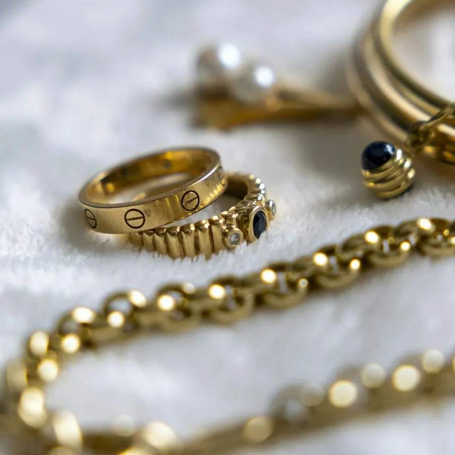 Gold rings and chains on soft fabric